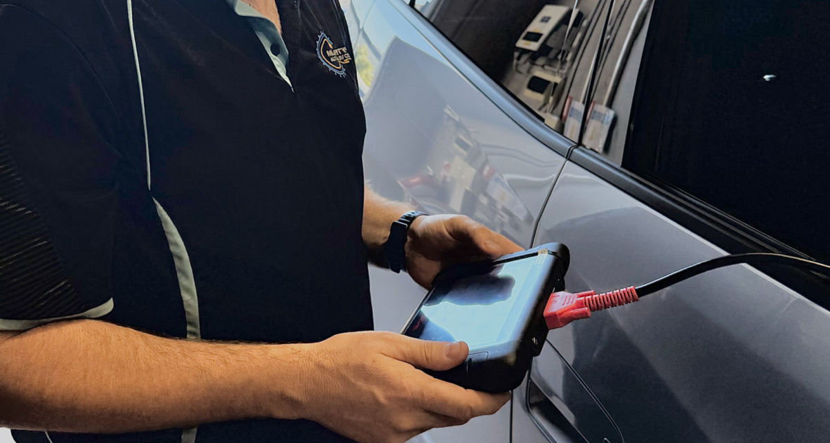 Contact Us 1 Shane Murty with diagnostics tool at Murty's Auto & EV Centre